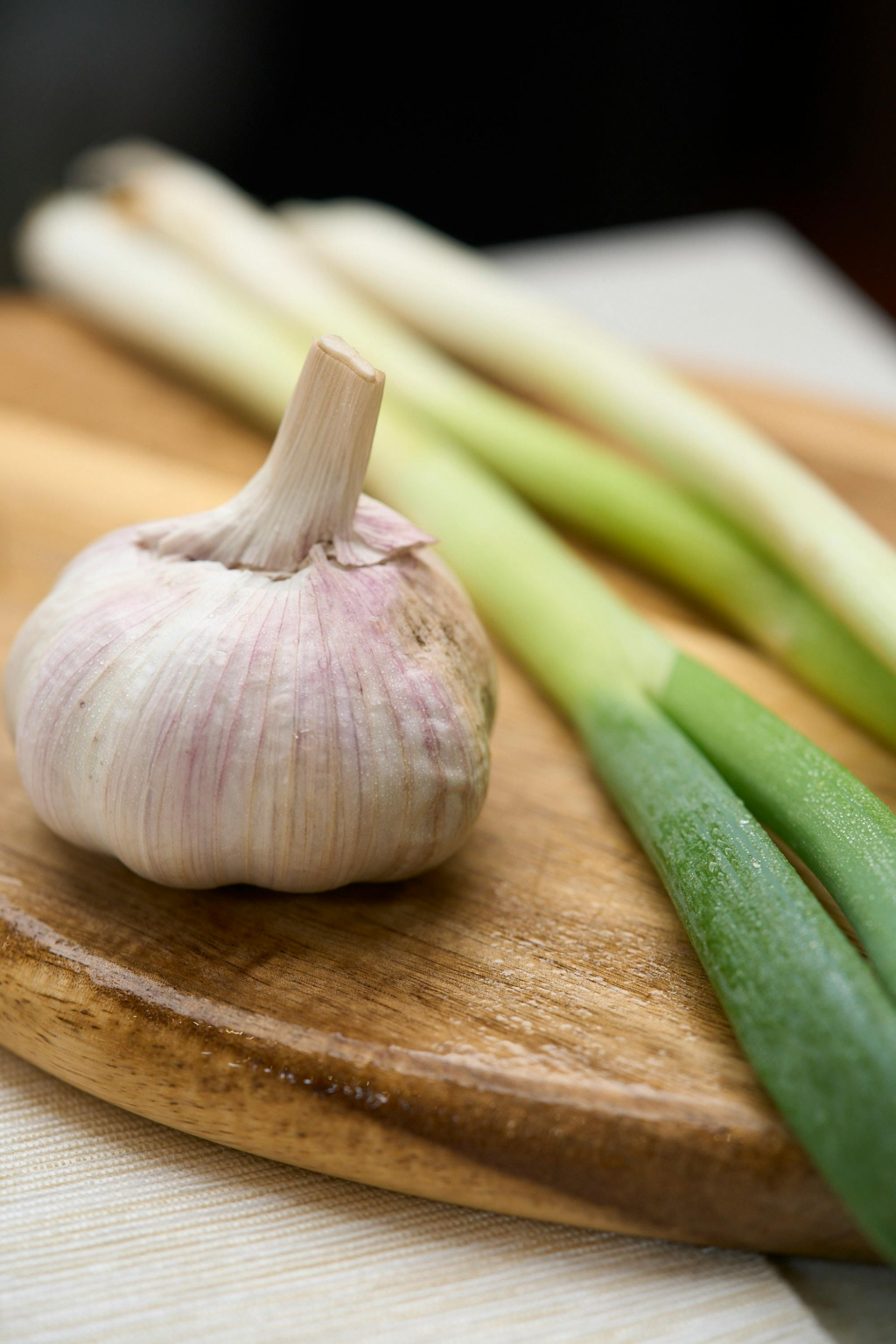 Garlic, spring onion on chopping board